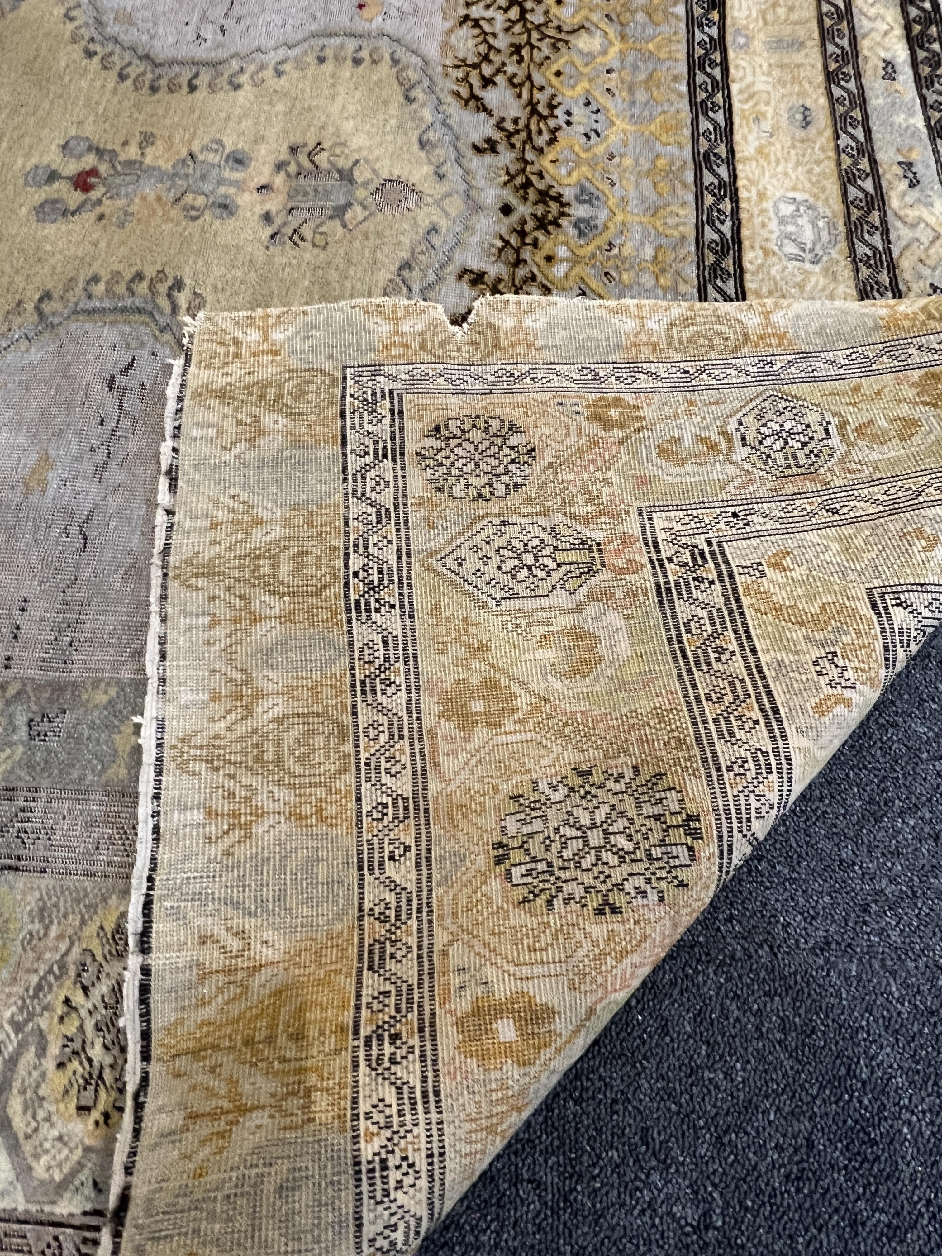 A Turkish silk prayer rug, with mihrab and stylised foliate borders on a gold ground, 185 x 137cm. Condition - the central panel severely worn to the tip of the mirror, lower fringe worn with losses.